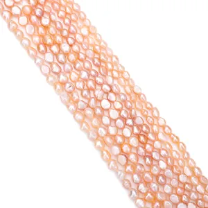 Diagonal strands of natural pinkish-orange freshwater baroque pearls for DIY jewelry making