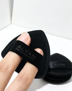 Detail view of ALYAN Rubycell black powder puff with elastic two-finger strap design