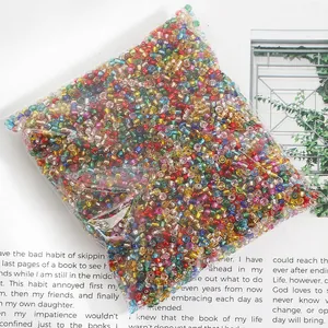 Close-up of a bag of multi-colored silver-lined glass seed beads for DIY jewelry making.