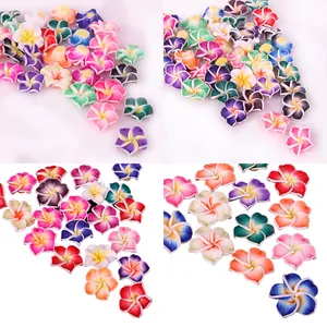 Macro view of colorful handmade frangipani polymer clay flower beads for DIY jewelry crafts