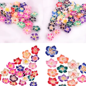 Detailed view of colorful five-petal polymer clay frangipani flower beads for DIY crafts.
