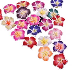 Detailed view of colorful assorted handmade polymer clay frangipani plumeria flower beads