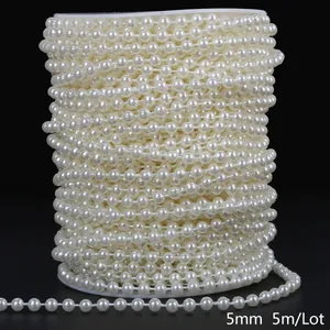 Detailed macro shot of 5mm cream white ABS faux pearl bead chain on a white spool