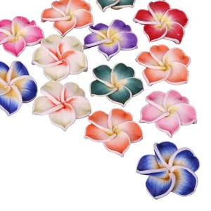 Close-up of colorful polymer clay frangipani flower beads for DIY jewelry and crafts