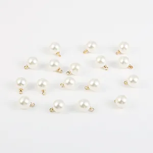 Vue rapprochée de perles ABS blanches avec anneaux dorés pour bijoux faits main