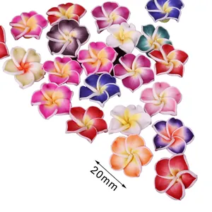 Detail view showing 20mm size of multi-colored polymer clay frangipani flower beads