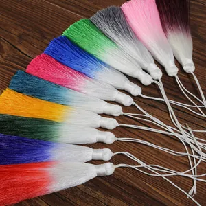 Detailed close-up showing variety of colorful 13cm gradient tassels on wood background