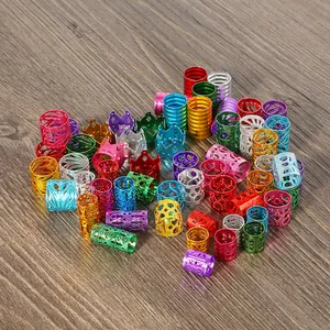 Macro detail of mixed color aluminum hair braid cuffs with filigree and crown designs