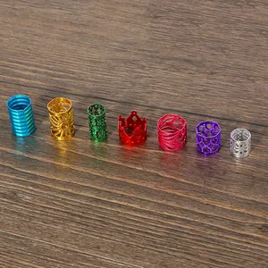 Detail view of seven colorful hollow aluminum beads with various patterns on wood.