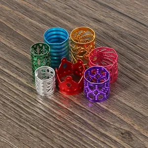 Detailed view of mixed color aluminum hair beads and DIY jewelry accessory mix on wood surface.