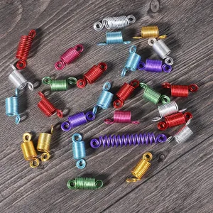 Close-up macro detail showing mixed colorful aluminum spring beads for handmade jewelry DIY