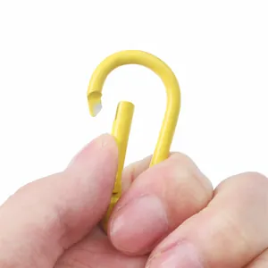 Close-up detail showing the opening mechanism of a yellow aluminum carabiner hook