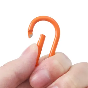 Sturdy orange aluminum gourd-shaped spring carabiner keychain being held by hand