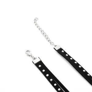 Macro detail of silver horse mouth clips on black velvet cord for DIY jewelry making