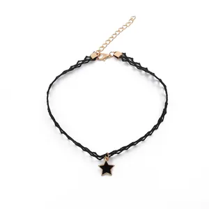 Detail view of black lace choker necklace with gold-accented black star pendant