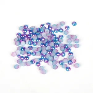 Macro view of iridescent blue and purple gradient flatback half-round ABS pearls