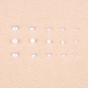 Macro view of various sized ABS flat-back half-round white AB imitation pearls