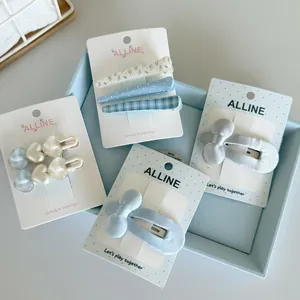 Close-up of floral series hair clip sets with bow and heart designs on display cards