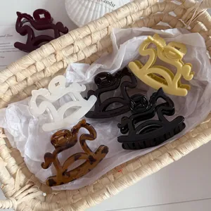 Macro detail of assorted colorful rocking horse hair claws displayed in a woven basket