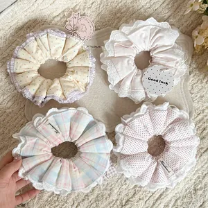 Close-up of handmade cotton scrunchies with delicate lace edges and polka dot patterns