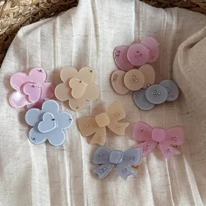 Close-up of translucent French style hair clips with rhinestones in blue and pink.