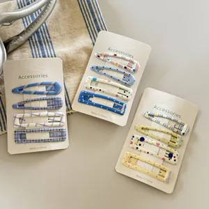 Detailed view of colorful polka dot and plaid hair clips on white display cards
