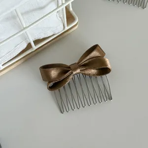 Detail view of a premium brown satin bow hair comb for elegant sweet hair styling