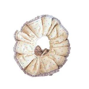 Sweet cream cotton scrunchie with colorful polka dots and purple lace trim