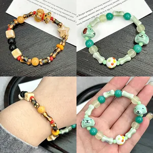 Detailed view of hand-painted ceramic bead bracelets with cute dog and bone charms