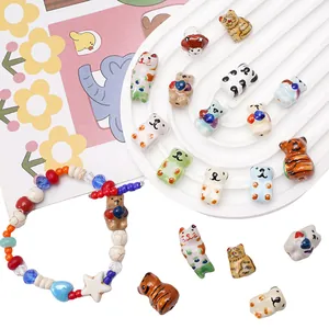 Close-up view of various colorful hand-painted ceramic animal beads for DIY jewelry crafts