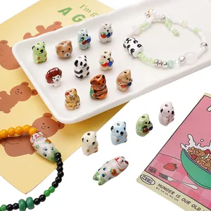 Detailed view of colorful hand-painted ceramic animal beads for DIY jewelry making.