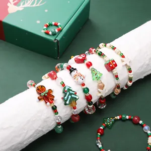 Close-up of festive Christmas DIY beaded bracelets and rings featuring holiday charms