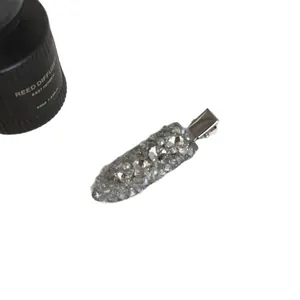 Sparkling silver hair clip covered in rhinestones and pearls for elegant hairstyles