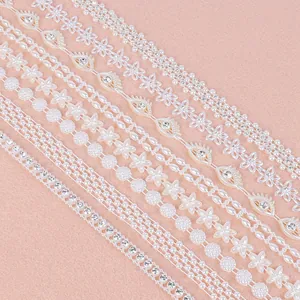 Detailed view of various white ABS pearl and crystal rhinestone strands for DIY jewelry making
