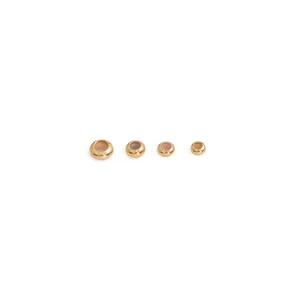 Detail view of four gold-plated copper beads with silicone inserts in varying sizes.