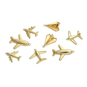 Detailed macro view of various gold-tone airplane pendants for DIY jewelry crafting