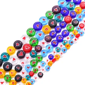 Close-up of colorful millefiori glass beads with red heart patterns for DIY jewelry