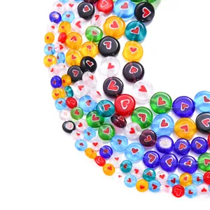 Macro view of colorful flat round millefiori glass beads with red heart pattern motifs