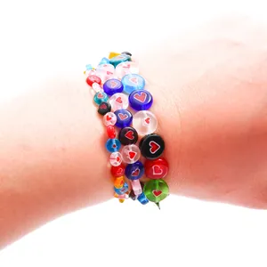 Handmade multicolor millefiori heart glass beads on wrist for DIY jewelry making
