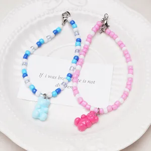 Detailed view of colorful acrylic gummy bear pendants on handmade beaded jewelry strands