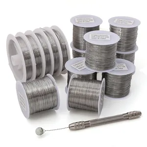 Close-up view of various sizes of stainless steel beading wire coils for DIY jewelry making
