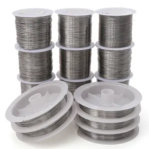 Professional set of stainless steel beading wires on white spools for DIY jewelry crafts