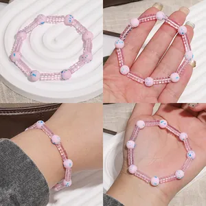 Detailed view of a pink and blue glass beaded bracelet shown from multiple angles