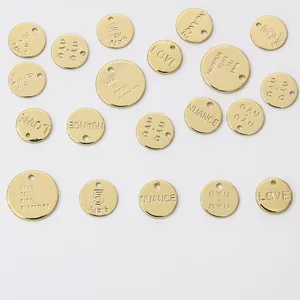 Detailed view of various 14K gold-plated engraved round charms for jewelry DIY.