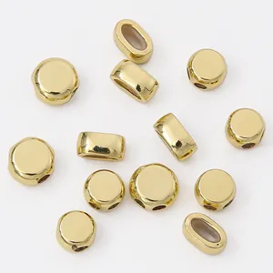 Macro view showing 14K gold filled double-hole flat round beads for jewelry DIY making.