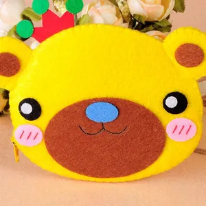 Detailed view of handmade cartoon bear felt bag showing soft non-woven fabric texture