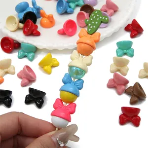 Macro view of colorful acrylic bow-knot hat charms for DIY handmade jewelry crafts