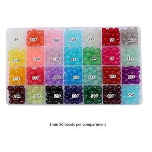 Detailed view of 8mm jelly-textured glass beads set in a 28-grid storage organizer box