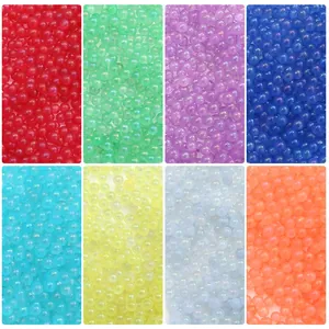 Macro view showing eight vibrant colors of luminous glass bubble beads for DIY resin crafts.