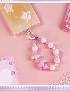 Close-up of cute pink beaded phone-shaped notebook charm with a sheep and cloud pendant